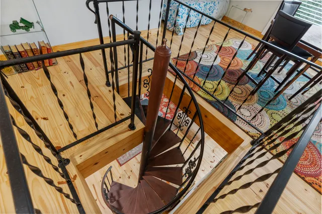 a view of a room with furniture and wooden floor