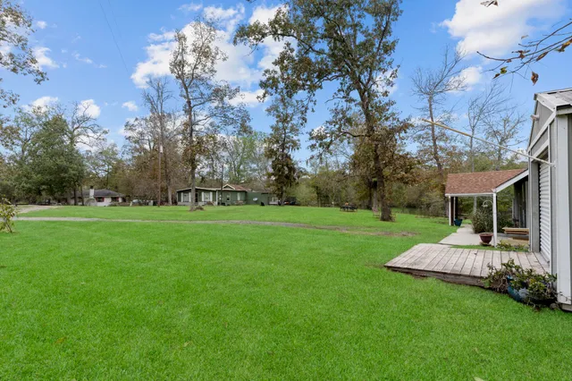 a backyard of a house with table and chairs