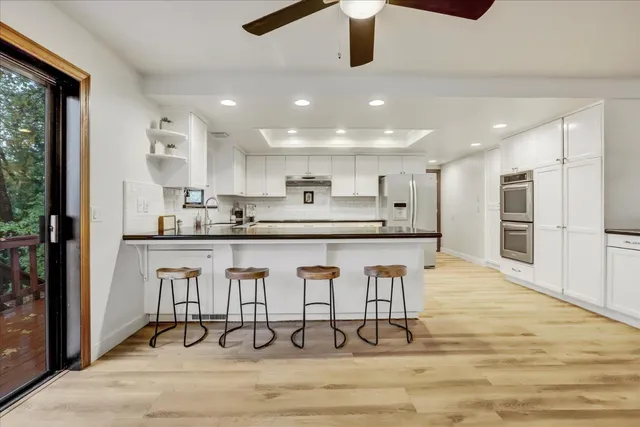 a kitchen with a sink a window and cabinets
