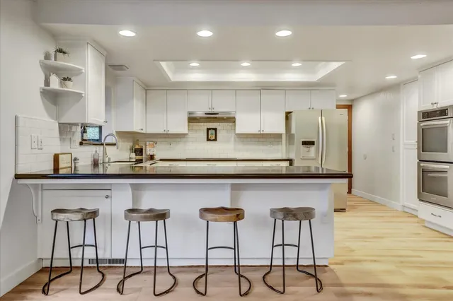 a stove top oven sitting inside of a kitchen