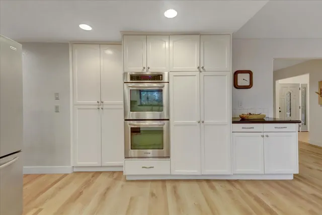 a bedroom with a bed and a potted plant