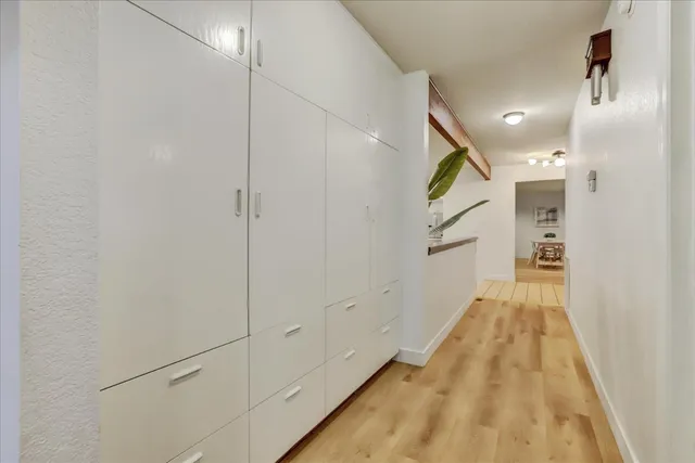 a view of roof deck with wooden floor and fence