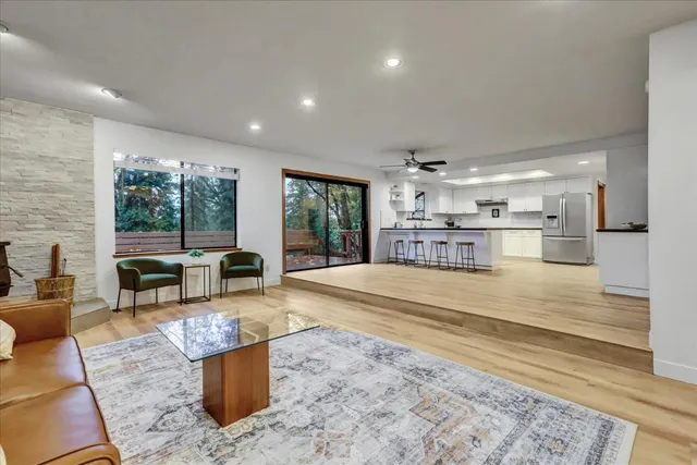 a kitchen with stainless steel appliances kitchen island granite countertop a refrigerator and microwave