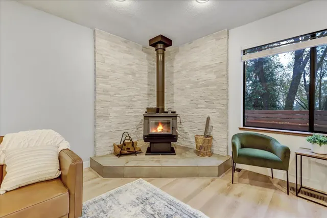 a kitchen with stainless steel appliances granite countertop a refrigerator a sink a stove and white cabinets with wooden floor