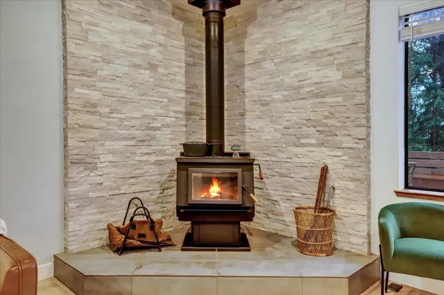 a kitchen with stainless steel appliances kitchen island granite countertop a table chairs refrigerator and microwave