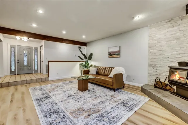 a kitchen with granite countertop a sink cabinets window and stainless steel appliances