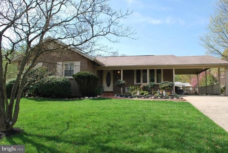 a view of a house with a yard and sitting area