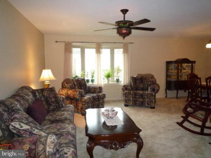 2013 Hopefield Road Silver Spring, MD 20905 - Photo 11 of 30 a living room with furniture a chandelier and a large window