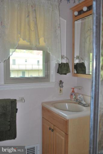 2013 Hopefield Road Silver Spring, MD 20905 - Photo 20 of 30 a bathroom with a sink and a mirror