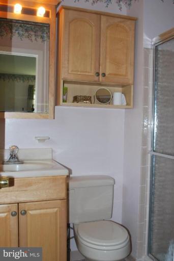 2013 Hopefield Road Silver Spring, MD 20905 - Photo 21 of 30 a bathroom with a toilet sink vanity and mirror