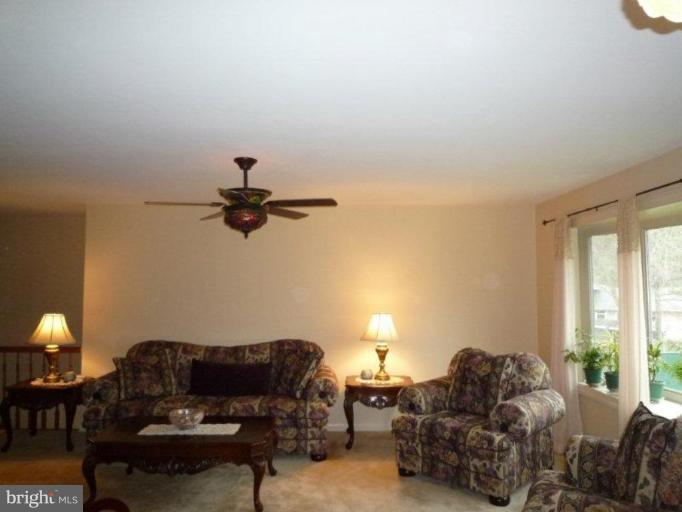 2013 Hopefield Road Silver Spring, MD 20905 - Photo 10 of 30 a living room with furniture a ceiling fan and a window