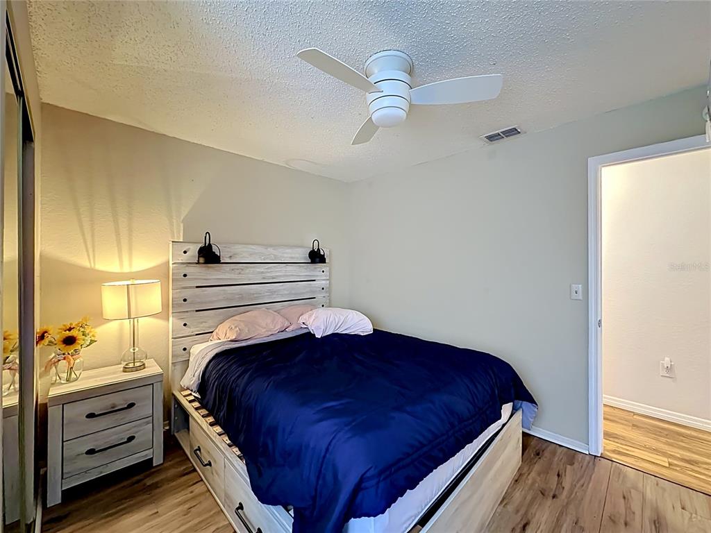 3705 Southwest 27th Street, Unit 922 Gainesville, FL 32608 - Photo 20 of 34 a bedroom with a bed and a dresser
