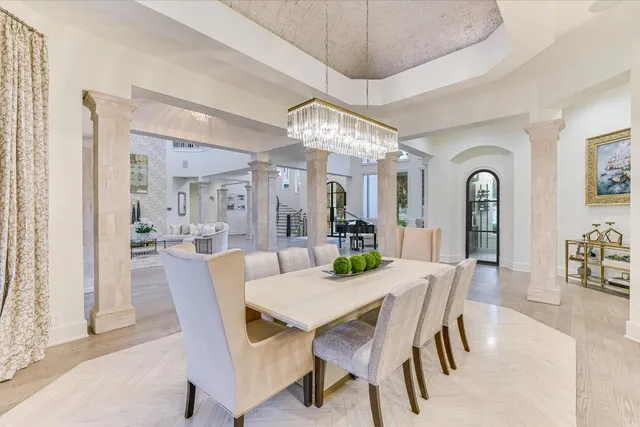 a view of a dining room with furniture and chandelier