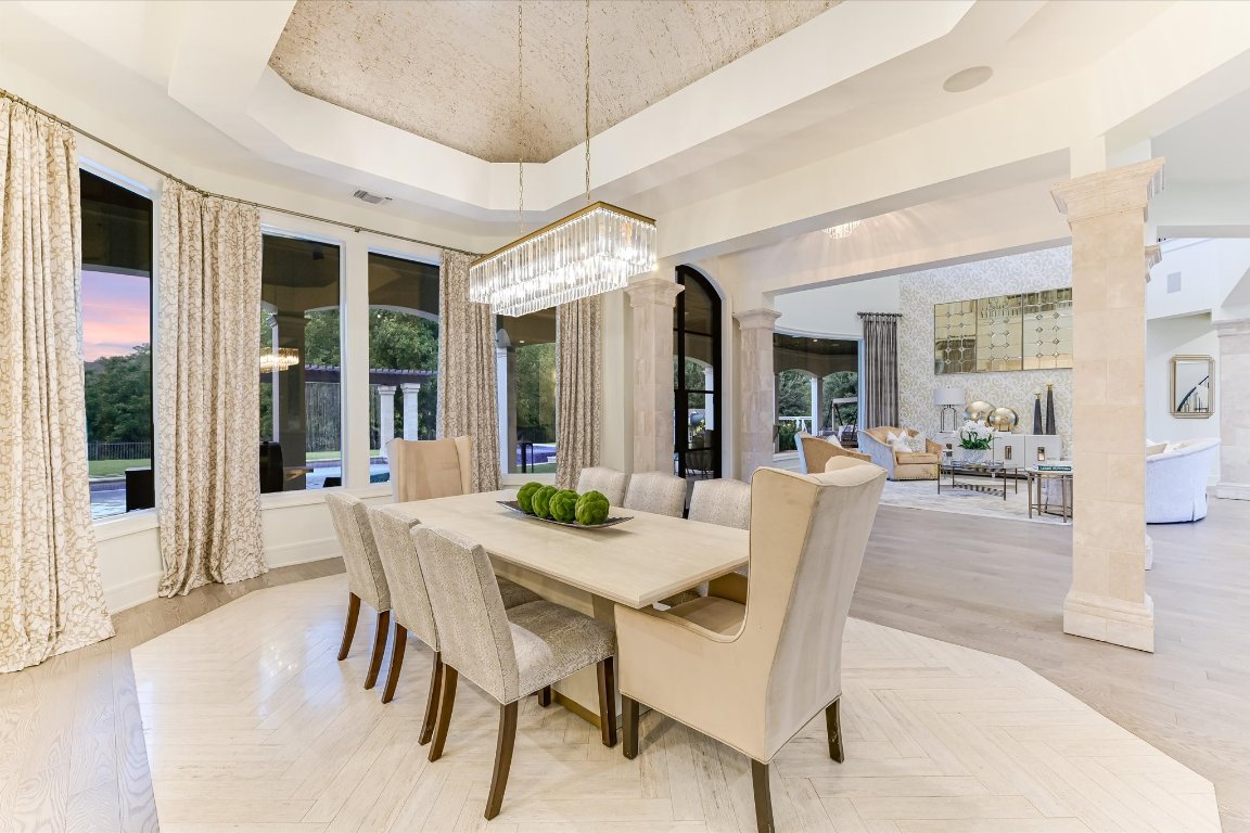 14132 Flat Top Ranch Road Austin, TX 78732 - Photo 12 of 40 a view of a dining room with furniture wooden floor and chandelier