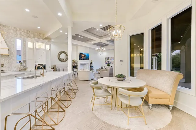 a dining room with granite countertop a table and chairs in it