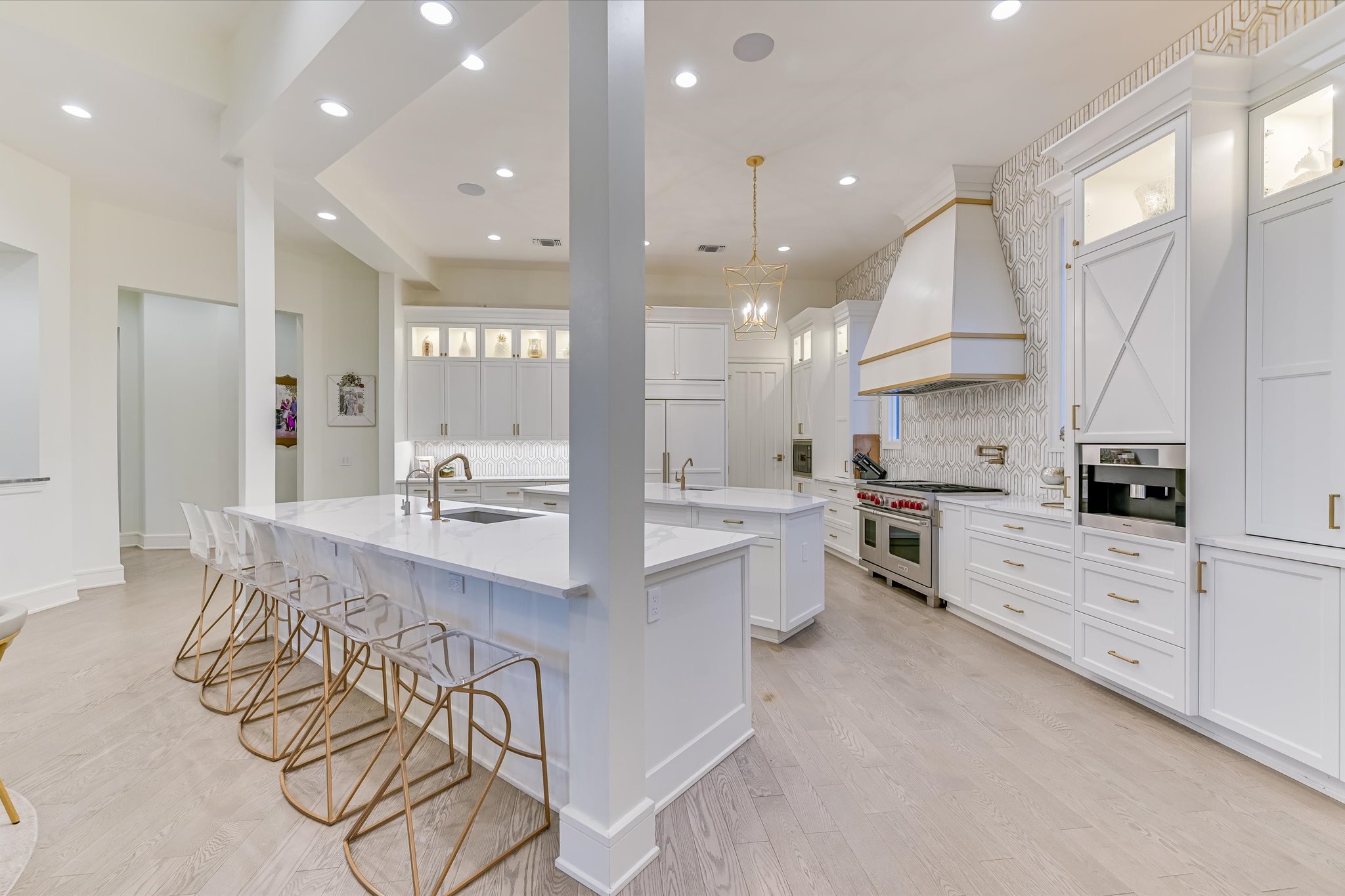 14132 Flat Top Ranch Road Austin, TX 78732 - Photo 14 of 40 a large white kitchen with lots of counter space a sink and appliances