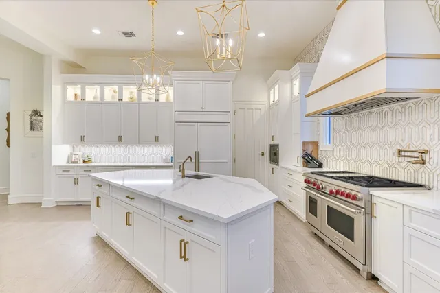 a kitchen with a stove sink and cabinets