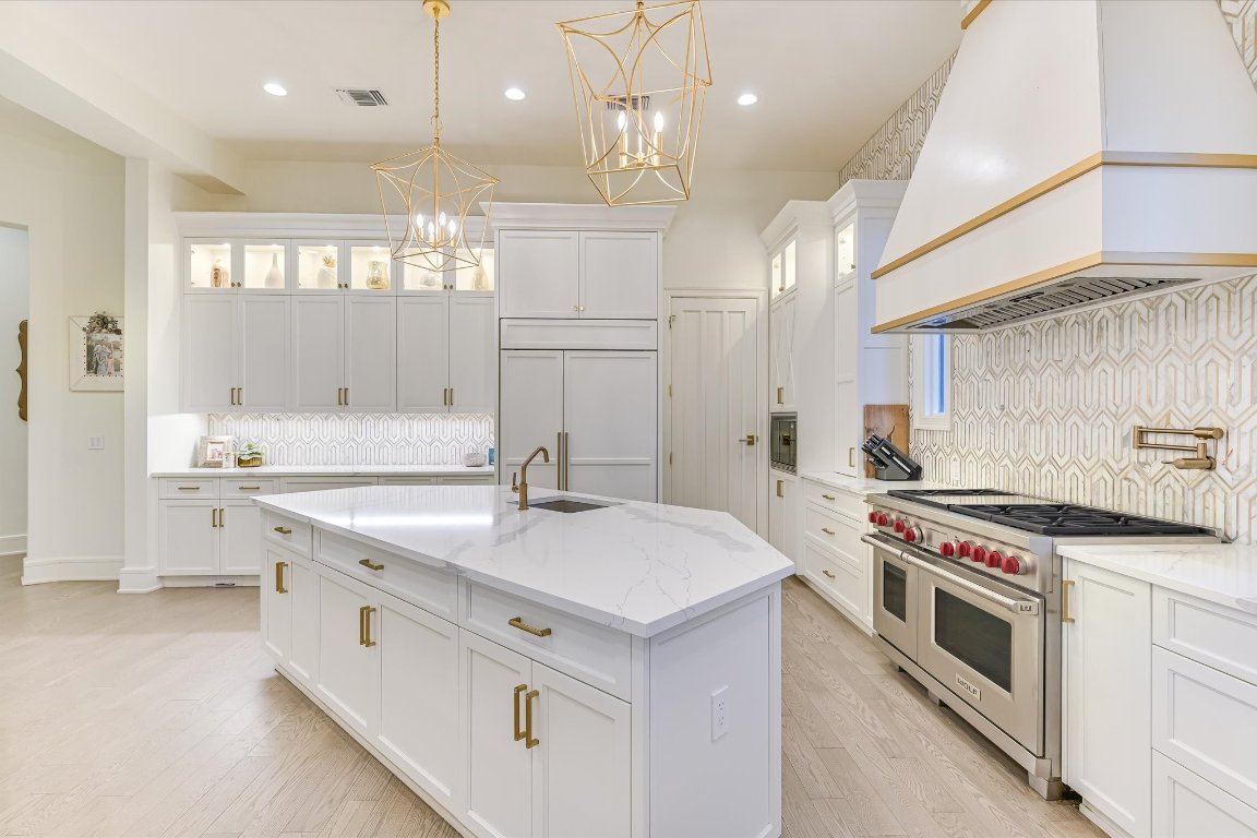 14132 Flat Top Ranch Road Austin, TX 78732 - Photo 15 of 40 a kitchen with a stove sink and cabinets