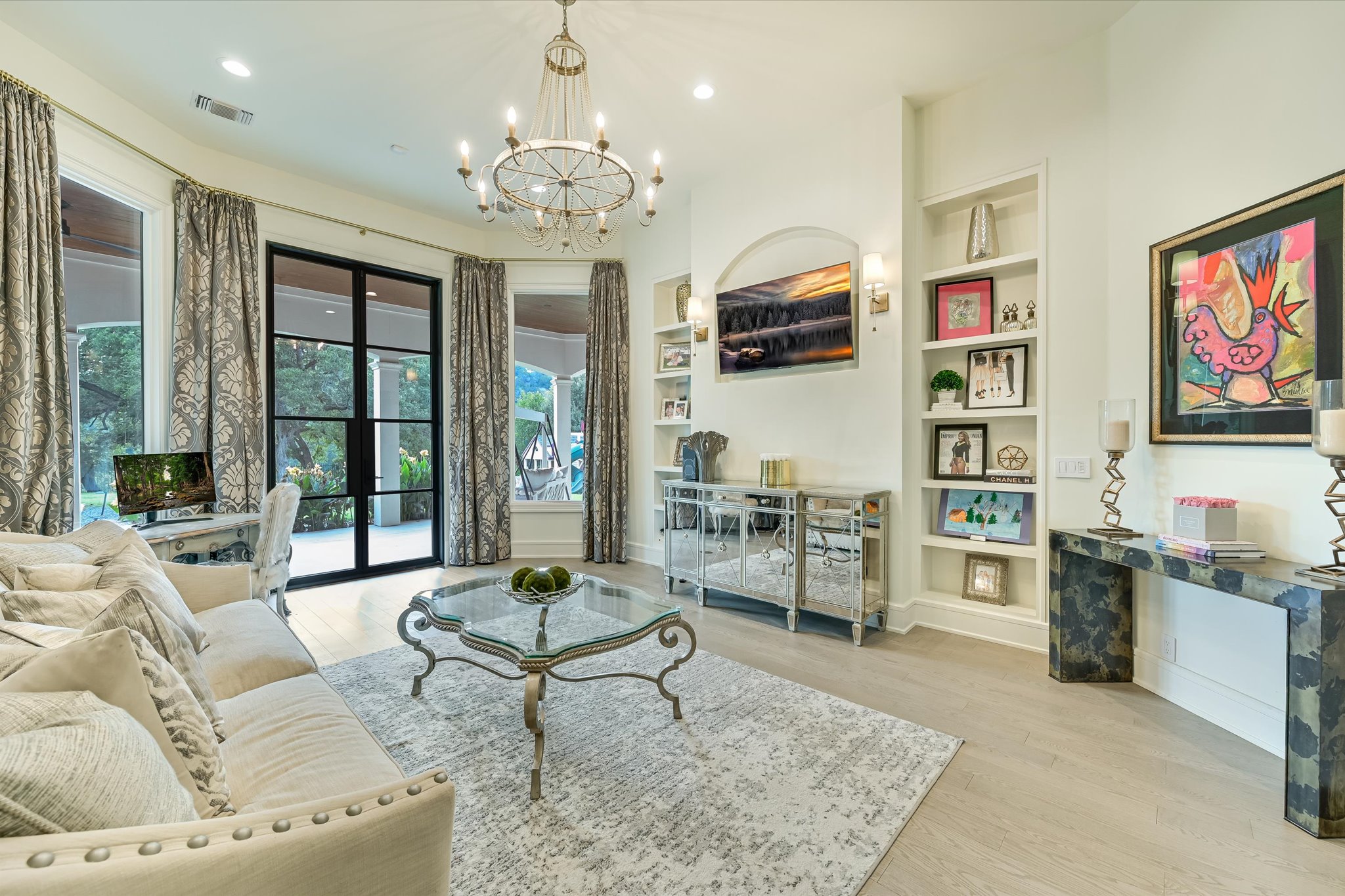 14132 Flat Top Ranch Road Austin, TX 78732 - Photo 17 of 40 a living room with furniture and a chandelier