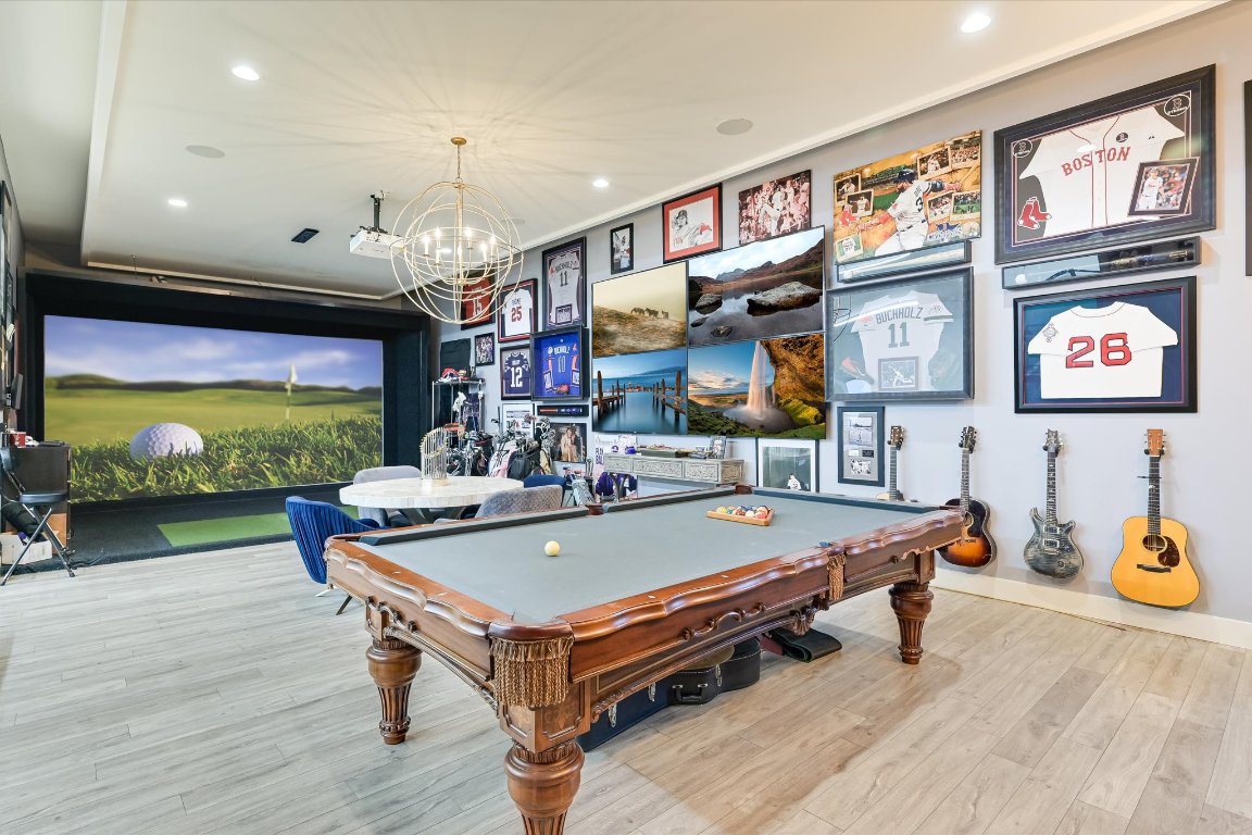 14132 Flat Top Ranch Road Austin, TX 78732 - Photo 24 of 40 a living room with furniture pool table kitchen view and a flat screen tv