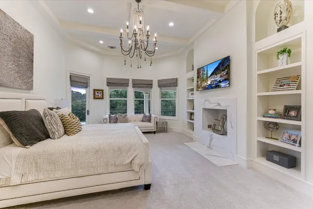 a spacious bedroom with a large bed and a fireplace