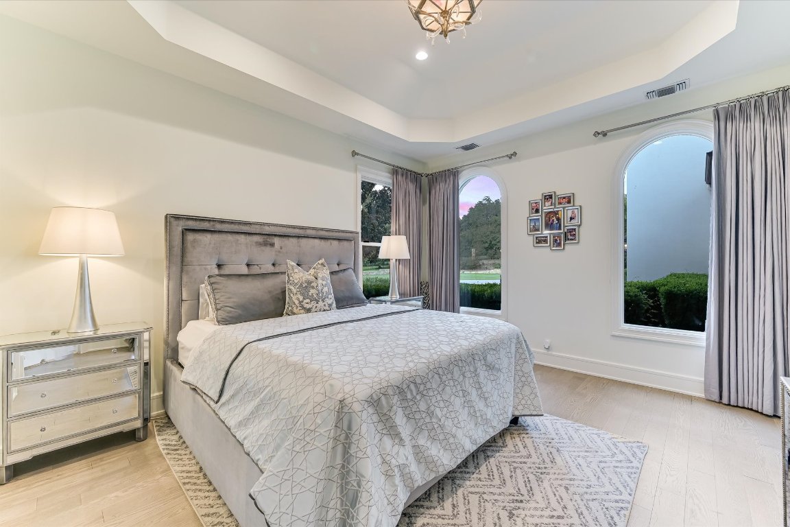 14132 Flat Top Ranch Road Austin, TX 78732 - Photo 29 of 40 a bedroom with a large bed and a window