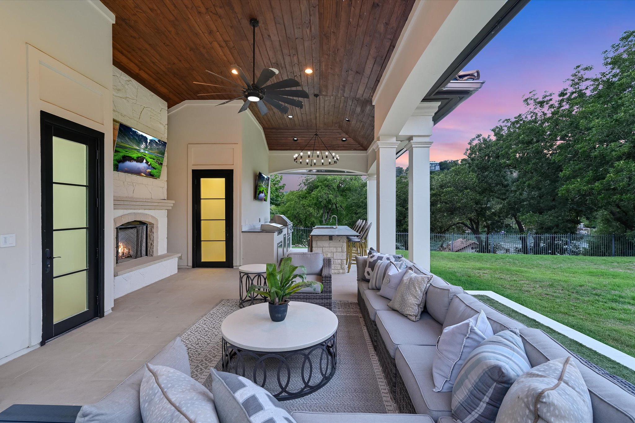 14132 Flat Top Ranch Road Austin, TX 78732 - Photo 31 of 40 a view of a patio with a dining table and chairs with a small yard