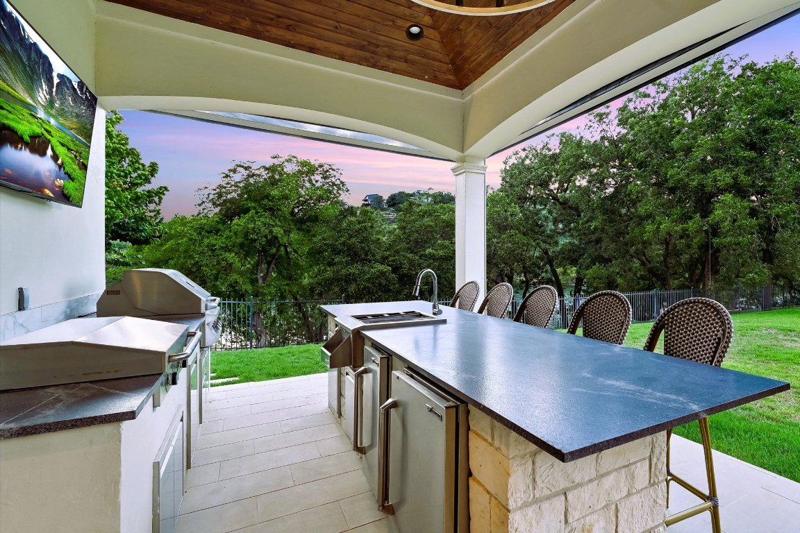 14132 Flat Top Ranch Road Austin, TX 78732 - Photo 32 of 40 a view of dinning table and chairs in patio
