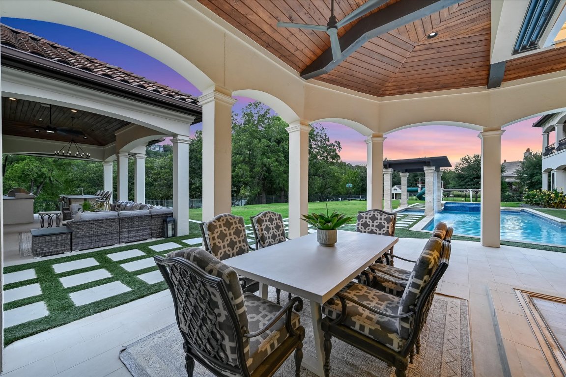 14132 Flat Top Ranch Road Austin, TX 78732 - Photo 34 of 40 a view of a patio with a dining table and chairs with wooden floor