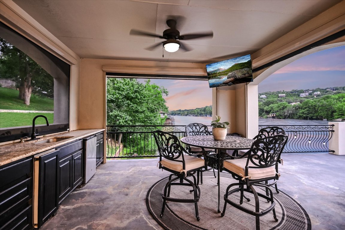 14132 Flat Top Ranch Road Austin, TX 78732 - Photo 36 of 40 a view of an outdoor dining space with a table and chairs