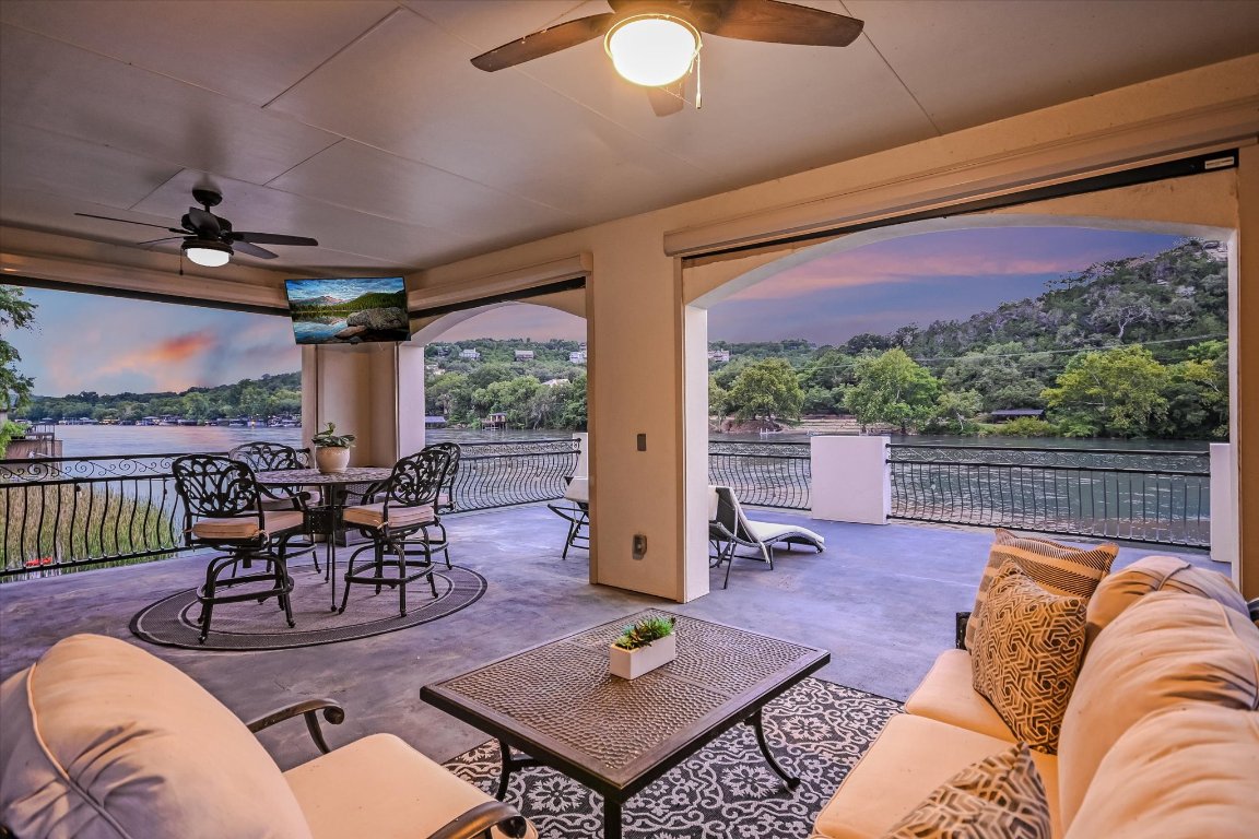 14132 Flat Top Ranch Road Austin, TX 78732 - Photo 37 of 40 a living room with furniture a rug and a large window