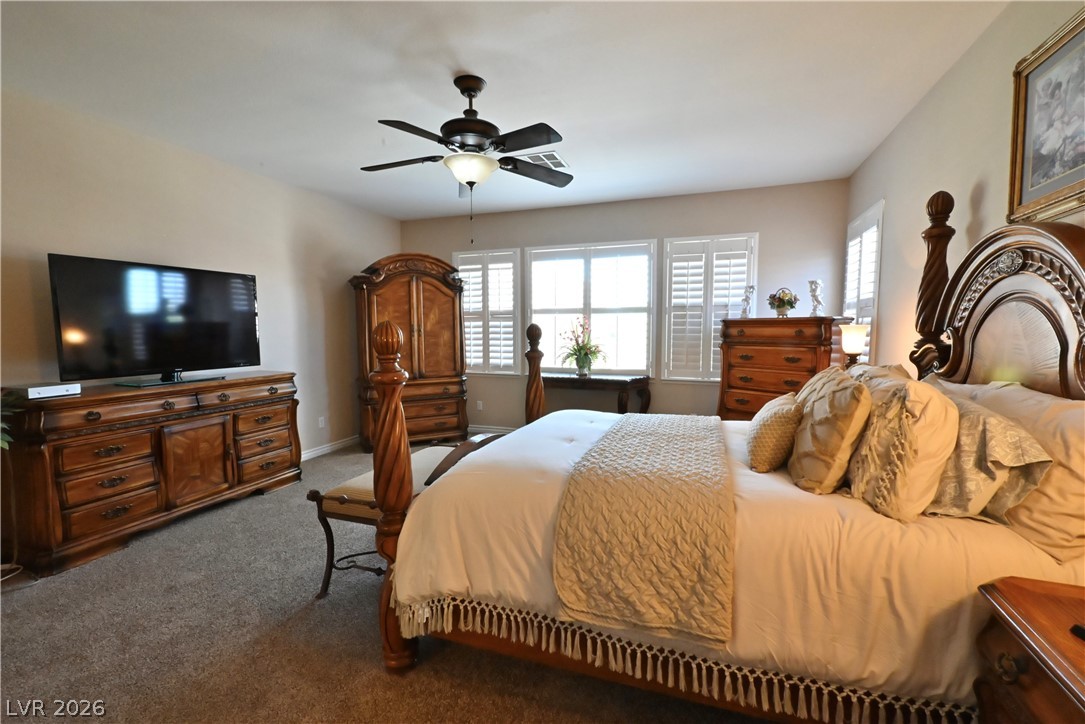 2729 Kildrummie Street Henderson, NV 89044 - Photo 28 of 42 A restful primary suite with a full wall of windows and plush carpeting.