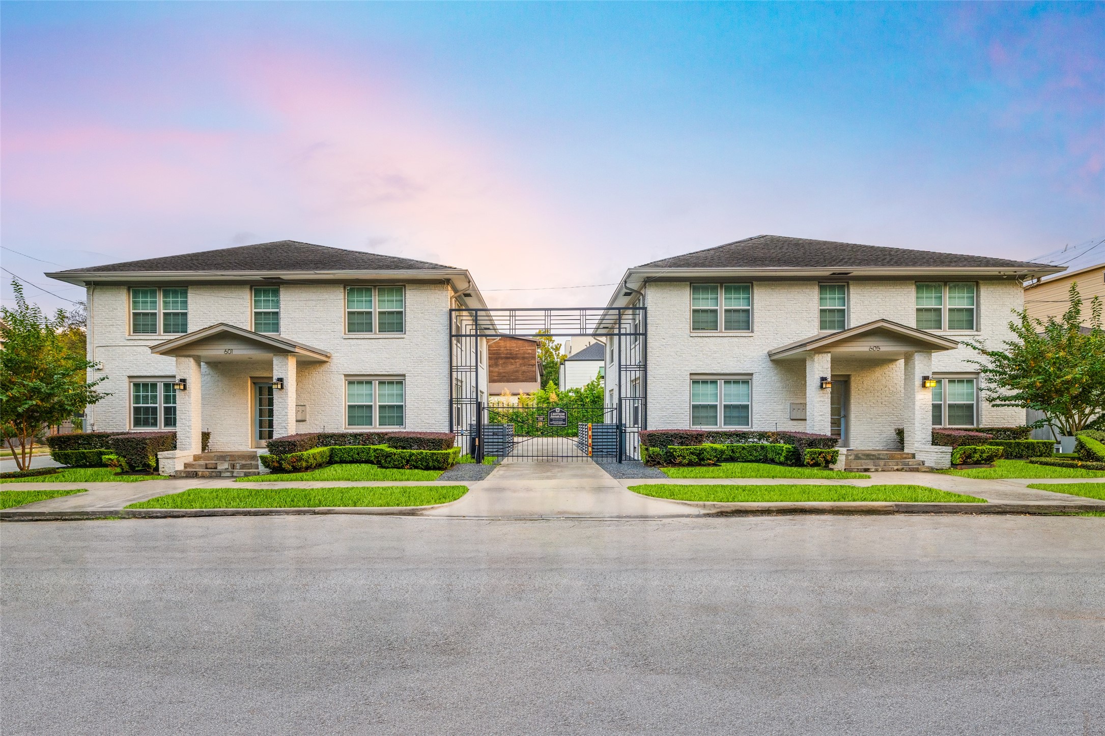 a front view of a house with a yard and trees