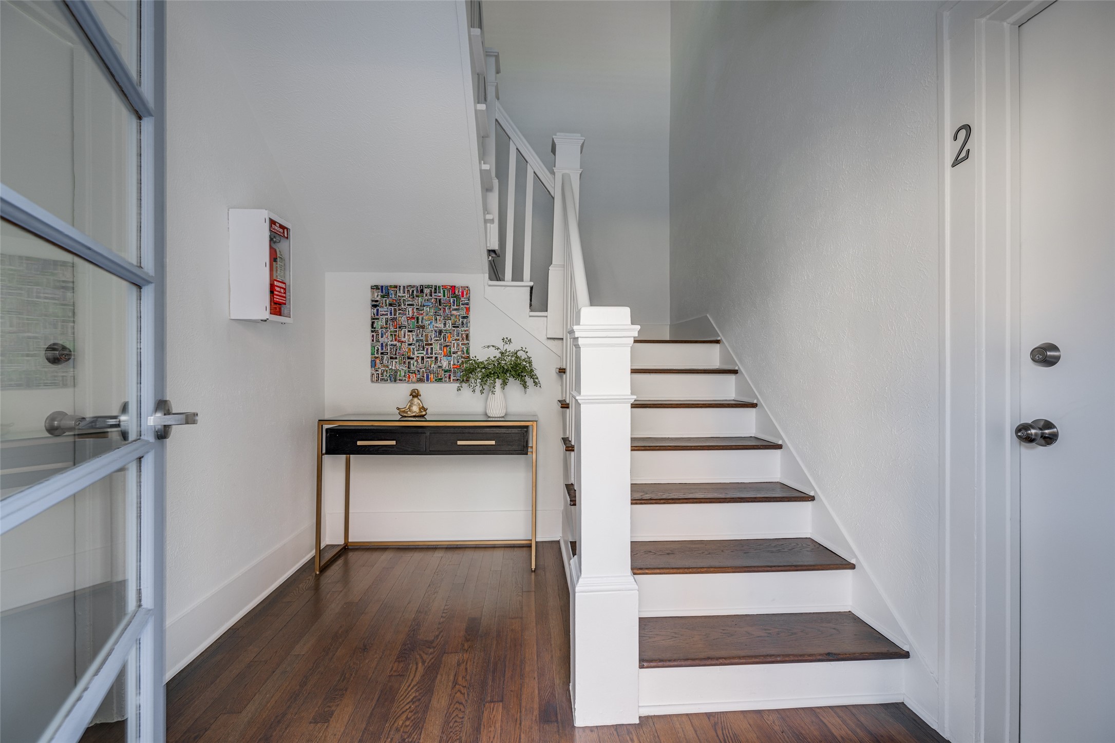 601 Bomar Street Houston, TX 77006 - Photo 9 of 28 a view of a hallway with wooden floor and staircase