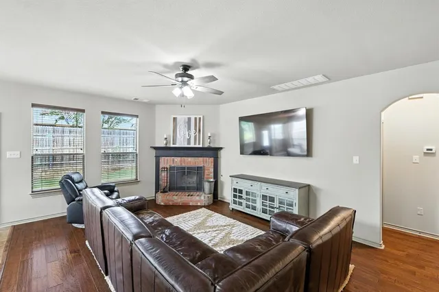 a bathroom with a sink a toilet a mirror and shower