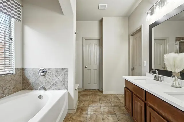 a living room with furniture and a book shelf