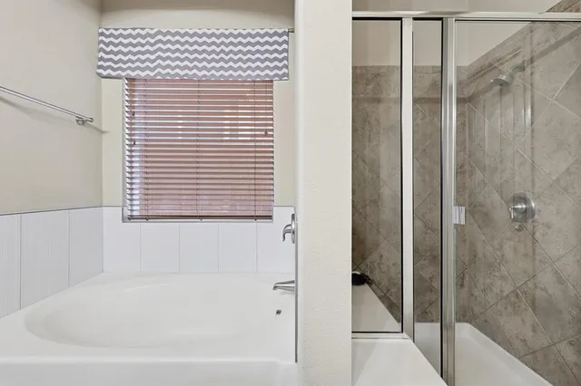 a bathroom with a bathtub and a shower