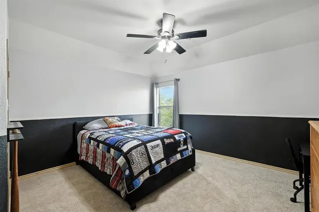 a view of a house with a yard and a large tree