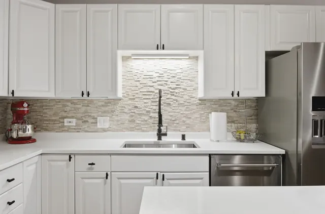 a kitchen with appliances cabinets and a sink
