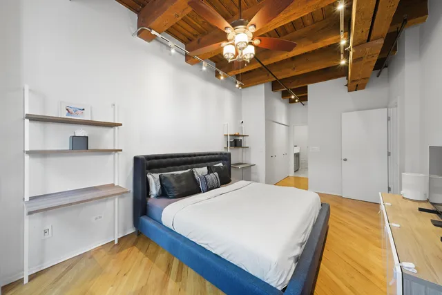 a bedroom with a bed and a chandelier