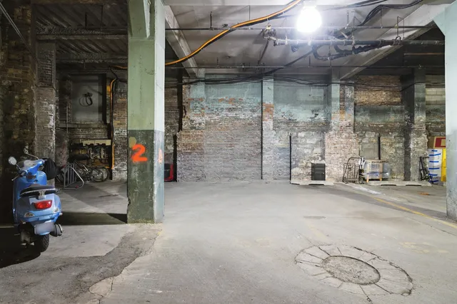 a view of a garage with rack and bicycle