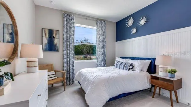 a bedroom with a large bed and a chandelier