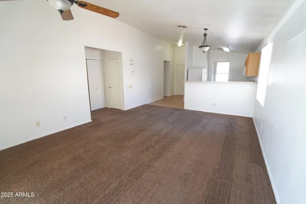 an empty room with a kitchen and a sink
