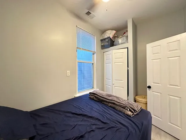 a bedroom with a bed and a window