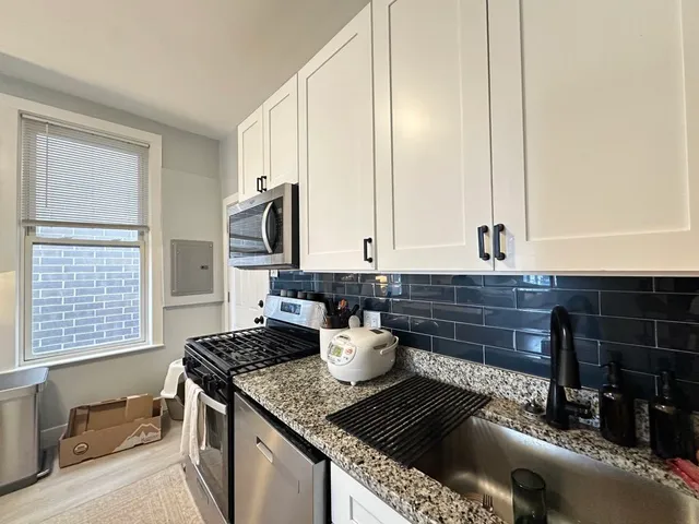 a kitchen with a stove and a window