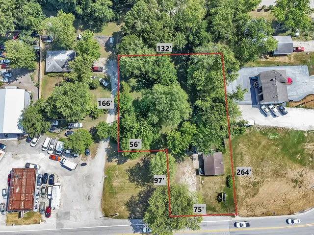 an aerial view of a houses with yard