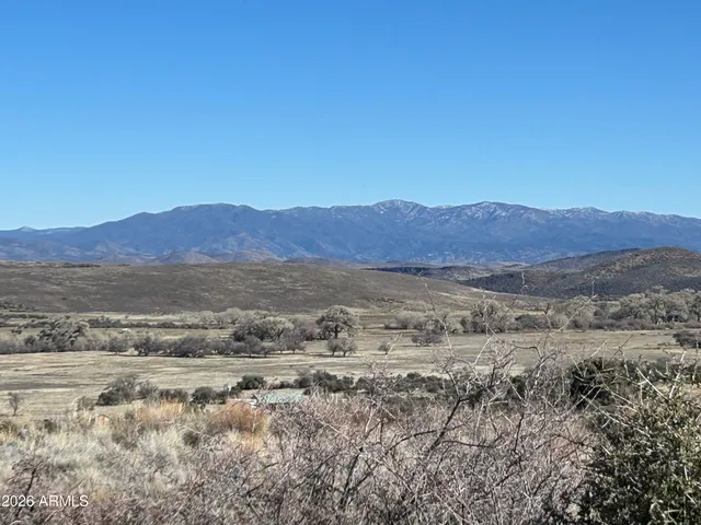 a view of a large mountain with a mountain in the background