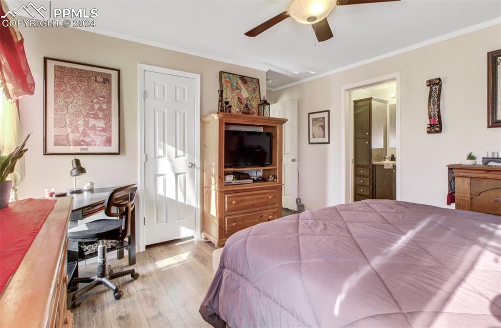 34220 Sanborn Road Yoder, CO 80864 - Photo 8 of 33 a bedroom with a bed and a chandelier