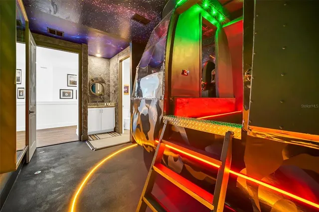 a kitchen with stainless steel appliances granite countertop a stove a refrigerator a kitchen island a dining table and chairs