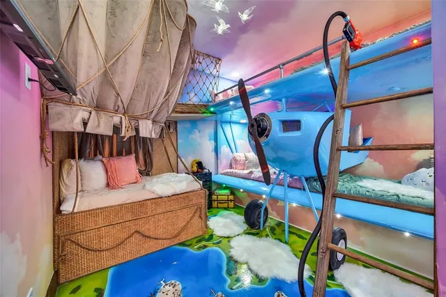 a kitchen with stainless steel appliances kitchen island granite countertop a table chairs refrigerator and microwave